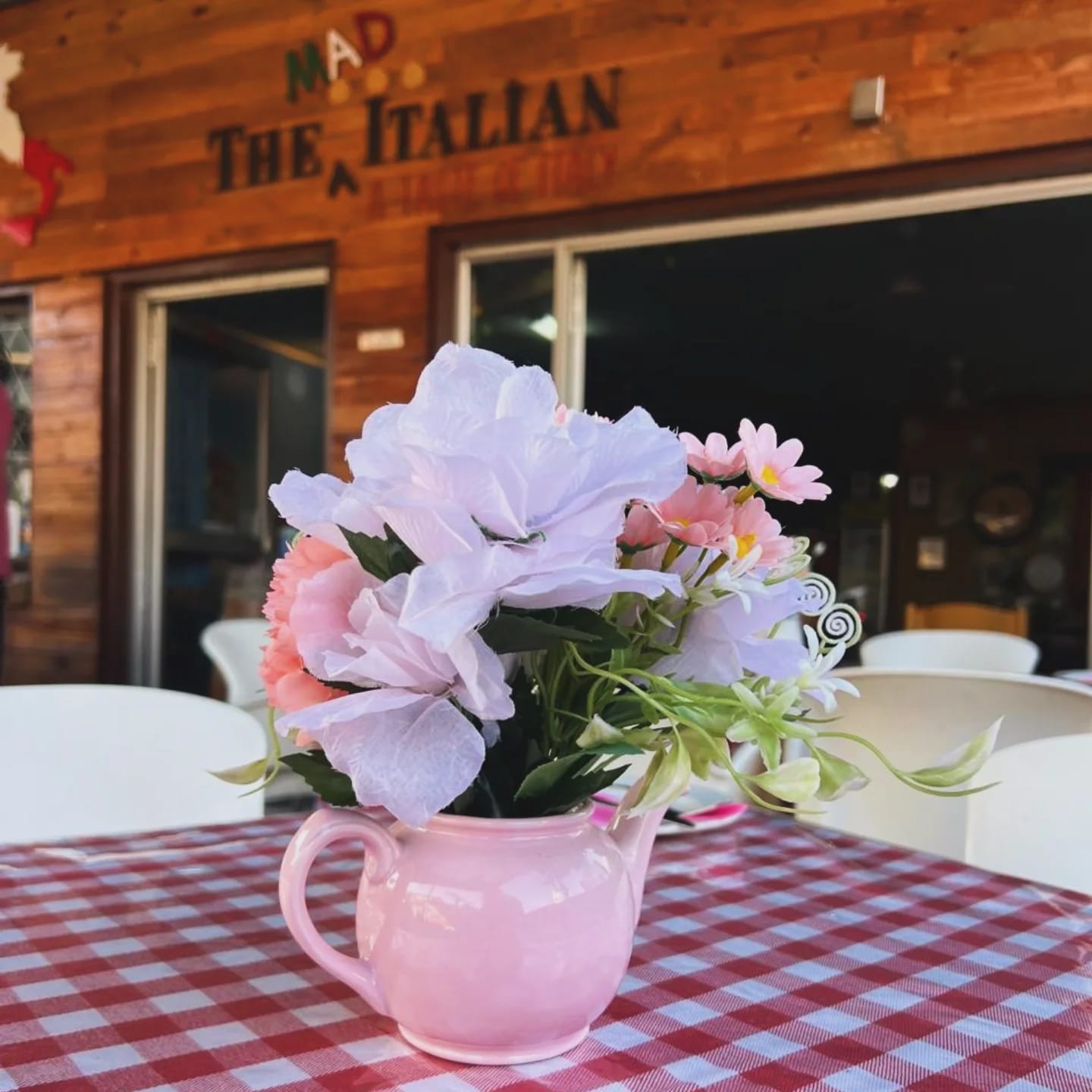 Café table setting with pink flowers